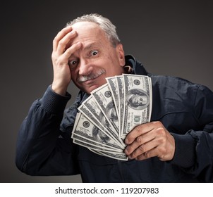 Lucky Old Man Holding With Pleasure Group Of Dollar Bills. Focus On Money