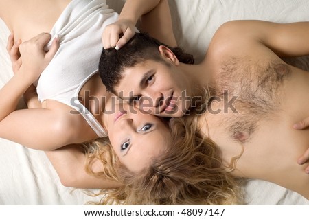 Similar – Man looking to beautiful woman lying on bed