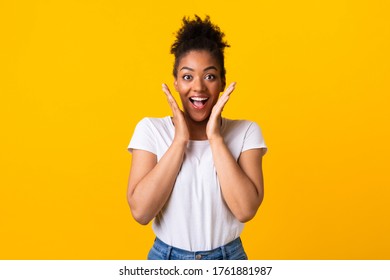 Lucky Person. Excited Black Girl Screaming With Joy Isolated Over Yellow Studio Wall, Copyspace