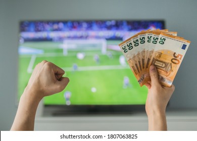 Lucky Winner At Football Betting With Euro Money In Hands Near The TV