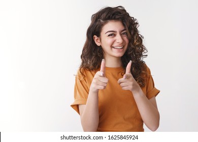 Lucky you bastard. Happy charming young female friend congratulating you pointing finger pistols camera smiling approval sister give blessing impressed brother good choice, standing white background