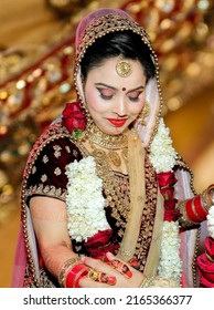 Ludhiana 7th March 2019 - Portrait of Hindu girl, beautiful stunning Indian hindu bride wearing a red traditional wedding dress, embroidered lehenga with heavy gold jewelery and a veil Smile tender

