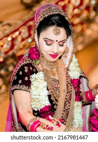 Ludhiana 7th March 2019 - Portrait of Hindu girl, beautiful stunning Indian hindu bride wearing a red traditional wedding dress, embroidered lehenga with heavy gold jewelery and a veil Smile tender  