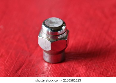 Lug Nut On A Red Background