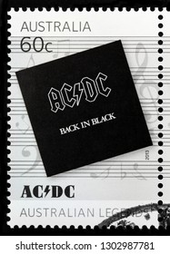 LUGA, RUSSIA - JANUARY 22, 2019:  A stamp printed by AUSTRALIA shows the cover of Back in Black - the seventh studio album by Australian rock band AC/DC (1980), circa 2013.
