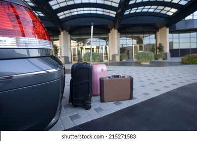 Luggage Beside Parked Car Outside Hotel