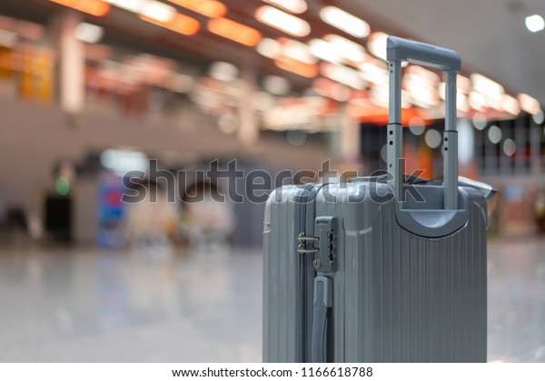 luggage holder on suitcase or bag with TRAVEL\
INSURANCE ,traveling luggages in an airport terminal,before\
passenger  and plane flying over sky,Can be used for montage or\
display your products