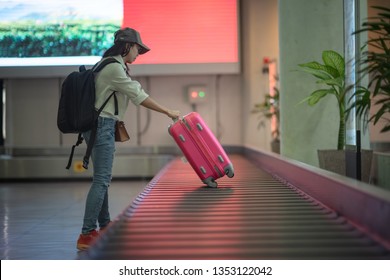 luggage reclaim at the airport in the transfer belt by woman traveler at the last stage of final call, arrival hall of the terminal
