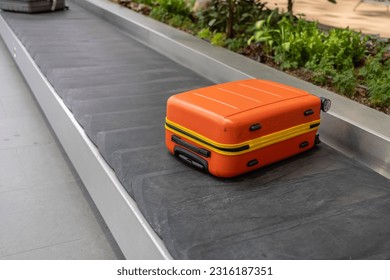 Luggage suitcase on the conveyor wait for passenger come to claim it at Terminal 3, Changi Airport, Singapore - Shutterstock ID 2316187351