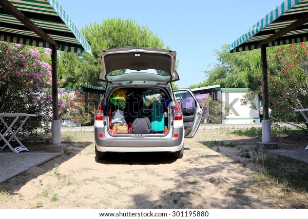 luggage and suitcases in car for departure for
summer holidays