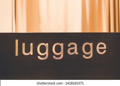 Luggage Text On Wooden Counter. No People.