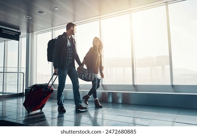 Luggage, travel and walking with couple in airport together for overseas journey, trip or vacation. Holding hands, love or smile with man and woman tourist in lobby, pulling suitcase for boarding