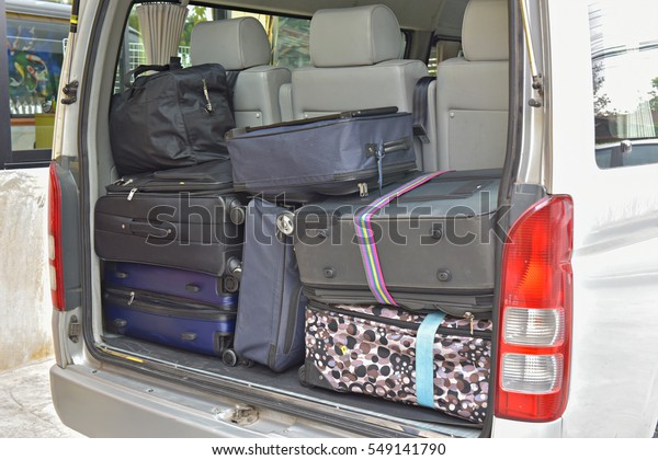Luggages and Bags arranged on the car van ready for\
a trip.