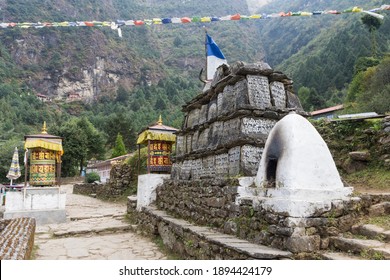 Lukla, Nepal - 10.22.2018: Mani stone wall and Tibetan Buddhist prayer wheels on the way from Lukla to Namche Bazaar, Everest Base Camp trek