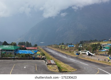 LUKLA, NEPAL - NOVEMBER 3: Airport Staff Look At One More Plane Takes Off From Tenzing-Hillary Airport - The Most Dangerous Airport In The World On November 3, 2013 In Lukla