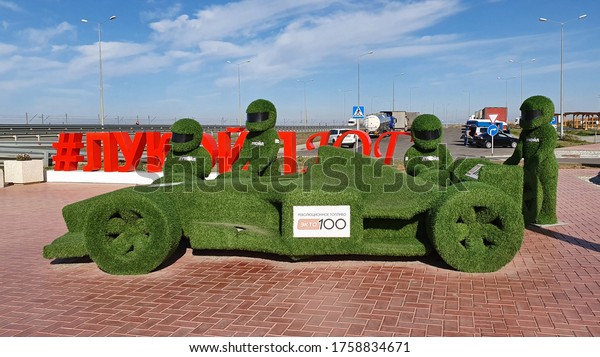Lukoyl gas station, Russia - October 14: Racing\
car and pilots from grass at a lukoyl gas station on October 14,\
2019 in Lukoyl gas station,\
Russia.