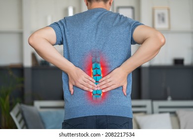 Lumbar intervertebral spine hernia, man with back pain at home, spinal disc disease, painful area highlighted in red - Shutterstock ID 2082217534