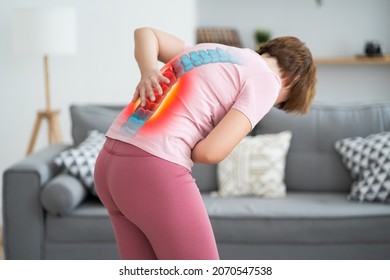 Lumbar intervertebral spine hernia, woman with back pain at home, spinal disc disease, health problems concept - Shutterstock ID 2070547538