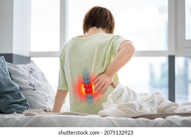 Lumbar intervertebral spine hernia, woman with back pain at home, spinal disc disease, health problems concept - Shutterstock ID 2075132923