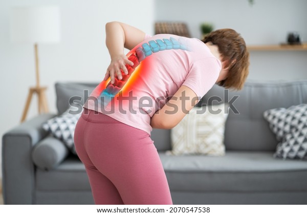 Lumbar\
intervertebral spine hernia, woman with back pain at home, spinal\
disc disease, health problems\
concept