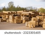 Lumber is stacked on the territory of a logging company. A large amount of lumber.