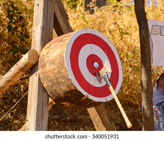 Lumberjack Axe Throwing Competition With Axe Stuck In Target