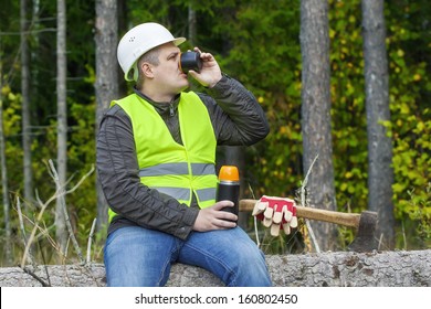 Lumberjack drinking tea from  plastic cup