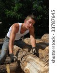 A lumberjack scaling a log
