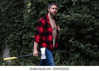 Lumberjack in shirt with heavy axe. Strong man work in forest. Lumber jack men in forest with axe. Lumberjack carries axe. Deforestation. Handsome man with axe. Lumberjack in the woods with an ax. - Powered by Shutterstock