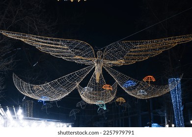 luminous decorative decor in shape of angel on street at night in winter at Christmas - Shutterstock ID 2257979791