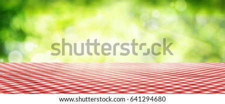 Luminous green spring background with a red checkered Tablecloth for a bavarian concept