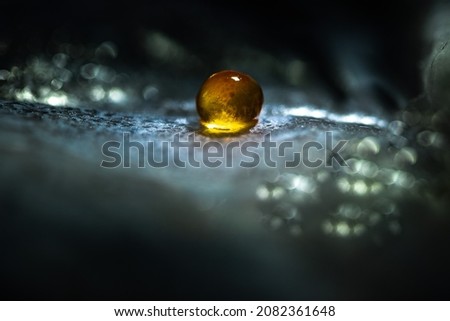 Luminous sphere in transparent shell. Fish egg as an example of the birth of a new life. The origin of the universe. The concept of the emergence of a new life. Magic fantasy 