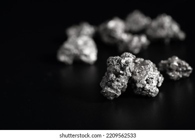 lump of silver or platinum or rare earth minerals on black background