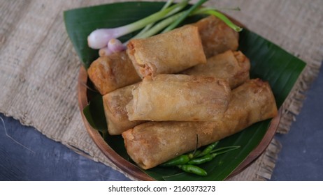 Lumpia Semarang On Wooden Plate With Spring Onion And Green Chilli. Indonesia Food.