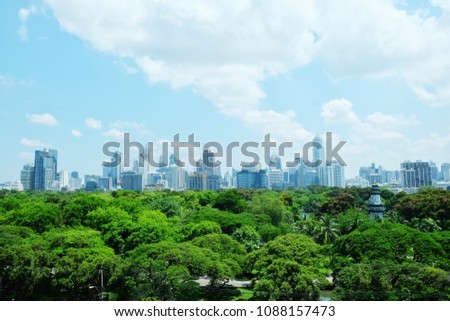 Lumpinee park with the view of city in Bangkok, a background of the city tower and the park in Bangkok, the view of office building and the park in Bangkok, forest in the city.