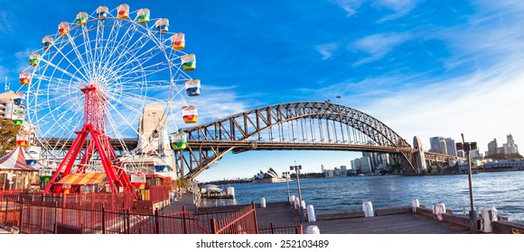  Luna park wheel with harbour bridge arch at sunset in Sydney, Australia.