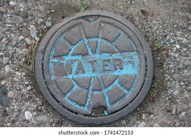 LUNA PIER, MICHIGAN/U.S.A.: MAY 24, 2020 : A Local Water Utility Line Manhole Cover In The Small Town Of Luna Pier, Michigan.