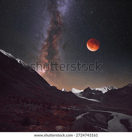 Lunar eclipse in the mountains against the backdrop of the Milky Way.