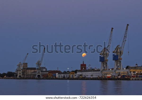 Lunar eclipse in sea\
harbor at Gda?sk