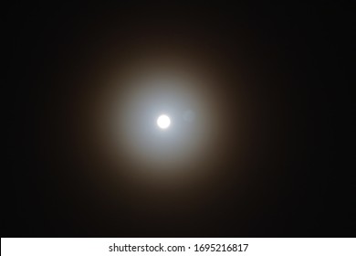 Lunar Halo Effect In The Dark Night Sky