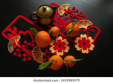 Lunar New year flat-lay with oranges, pot and Chinese wish characters 
