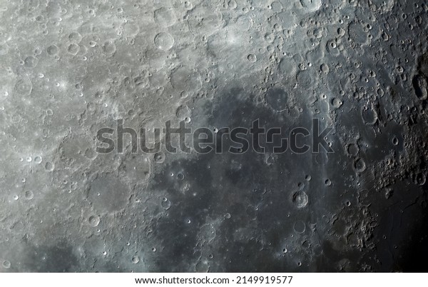 Lunar surface photographed in color. Many\
terrain formations are visible, such as craters, highlands,\
lava-flooded areas of the lunar mare, and traces of blowout\
material from crater\
formation.