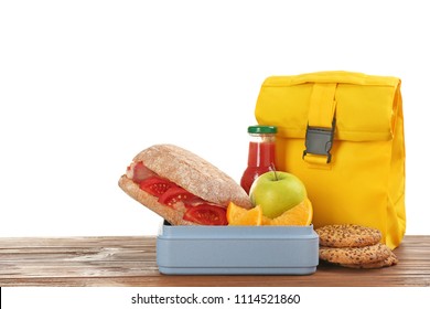 Lunch Box With Appetizing Food And Bag On Table Against White Background