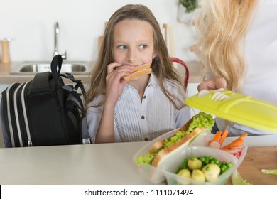 Lunch Box With Appetizing Food And School Bag On Kitchen Background. Homemade School Sandwiches.Packing In School Lunchbox.Mom Preparing School Snack Or Lunch For Her Daughter In Home Kitchen.