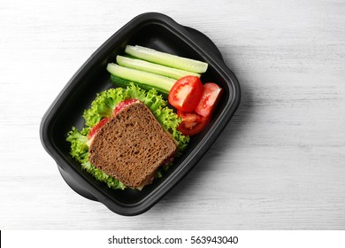 Lunch Box With Food On Wooden Background, Top View