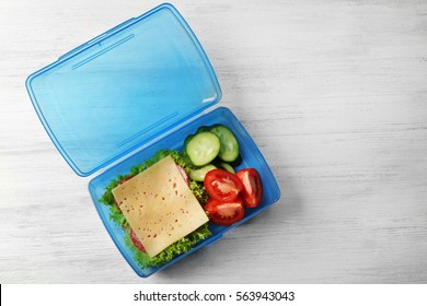 Lunch Box With Food On Wooden Background, Top View