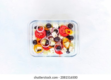 Lunch Box With Greek Salad, Glass Container, White Background, Top View