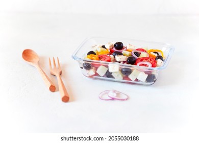 Lunch Box With Greek Salad, Reusable Glass Container, Wooden Cutlery, On White Background, Side View