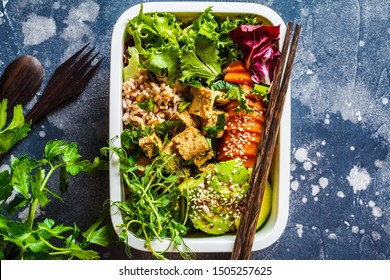 Lunch Box With Healthy Vegan Food. Bento Box With Rice, Tofu And Vegetables, Dark Background.