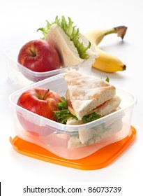 Lunch Box With Sandwich And Apple On White Background